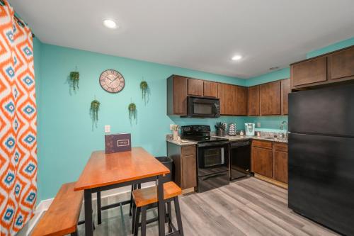 a kitchen with a table and a black refrigerator at Convenient 1BR Unit Close to Shopping & Dining in Houston