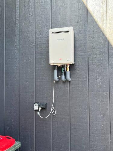 a wall with a electrical box on it at Rusty's Ridge in Jindabyne
