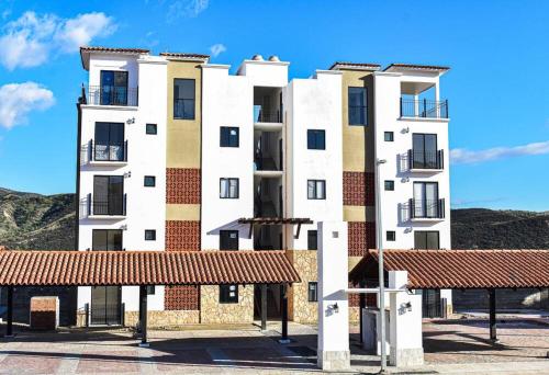 a tall white building with a red roof at Mar Báltico 2 in El Suazal