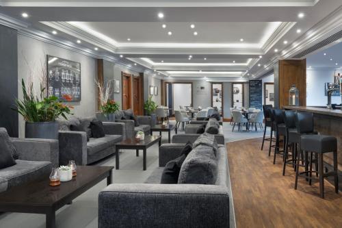 a living room with couches and a bar at Delta Hotels by Marriott Bristol City Centre in Bristol