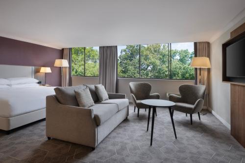 a hotel room with a bed and a couch and a table at Delta Hotels by Marriott Bristol City Centre in Bristol