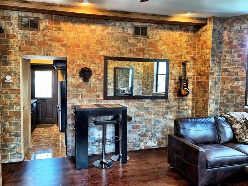 a living room with a couch and a brick wall at The Picasso on Lincoln Park in Chicago