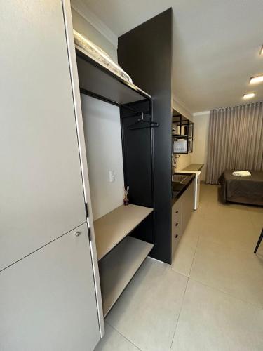 a black and white refrigerator in a room at Prédio San Paolo - Bairro Santa Mônica próximo a UFU / Prefeitura / Center Shopping in Uberlândia