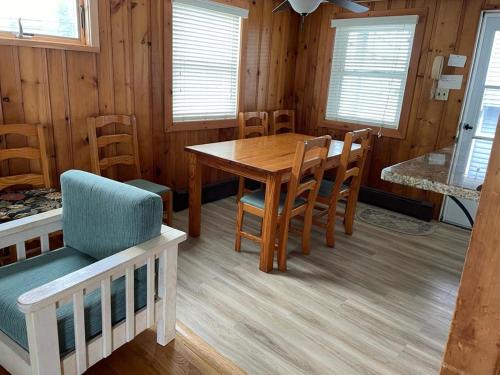a dining room with a wooden table and chairs at Well Maintained First Floor Duplex Close To The Ocean And Bay Beach In Harvey Cedars in Harvey Cedars