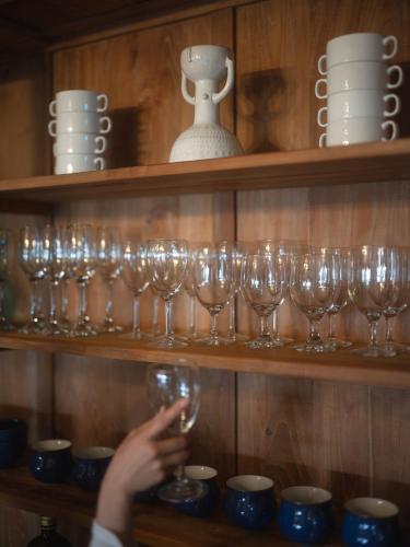 a person holding a wine glass on a shelf at Ocean View Riad Jeju in Jeju