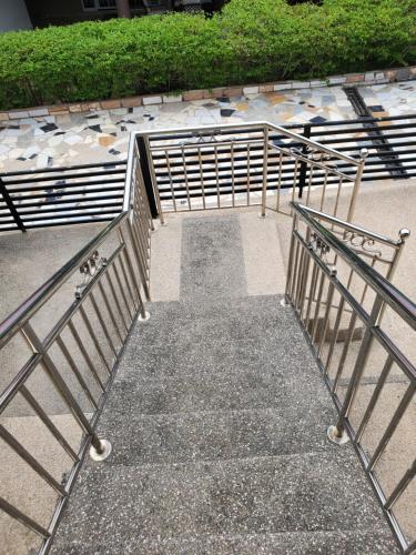 a set of stairs with metal railing in a park at Casa Consuelo Guest House in Takoradi