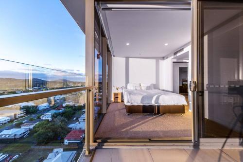 a bedroom with a bed and a view of a city at Modern APT in Toowong with Mountain View in Brisbane