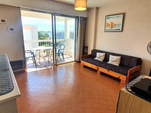 d'un salon avec un canapé et un balcon. dans l'établissement Appartement 2 pièces avec parking et wifi, centre-ville Sainte-Maxime - FR-1-780-69, à Sainte-Maxime