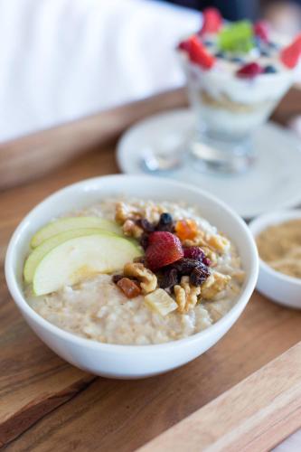 a bowl of oatmeal with fruit and nuts on a table at The Westin Copley Place, Boston in Boston