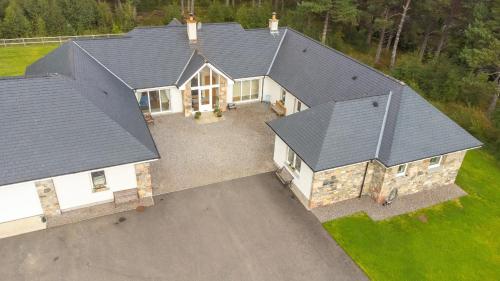 an aerial view of a house with a roof at The Bellhouse - hot tub lodge in Tomatin in Tomatin