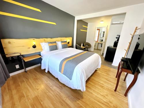 a bedroom with a large bed and a wooden floor at Duncan Motel in Duncan