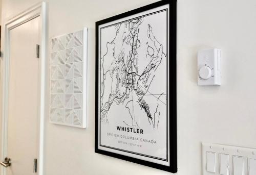 a picture of a map hanging on a wall at 2BR 2BA Whistler Escape with Newly Renovated Hot Tub, Steps from Olympic Rings and Cafes in Whistler