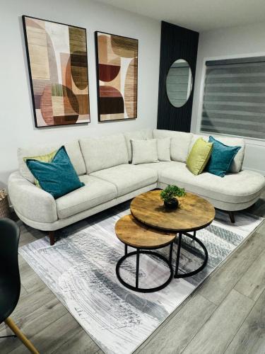 a living room with a couch and a table at The Glacier Royale - 1 Bed Suite in NW Calgary in Calgary