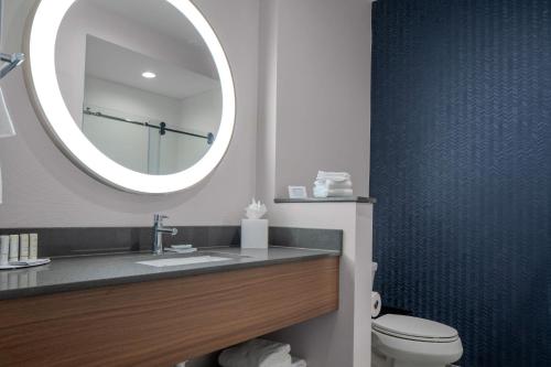 a bathroom with a sink and a mirror at Fairfield by Marriott Inn & Suites Dallas McKinney in McKinney