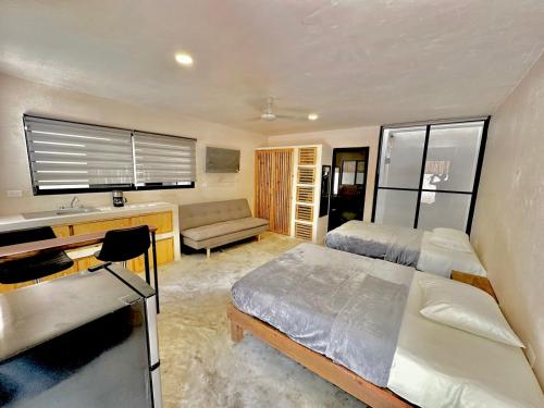 Ένα ή περισσότερα κρεβάτια σε δωμάτιο στο Suites Bacalar