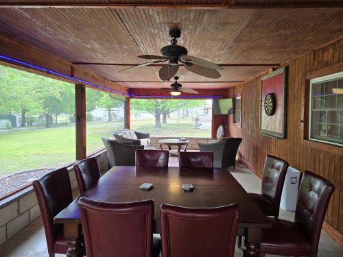 a dining room with a table and chairs and a ceiling fan at The Perfect Porch Retreat in Eufaula