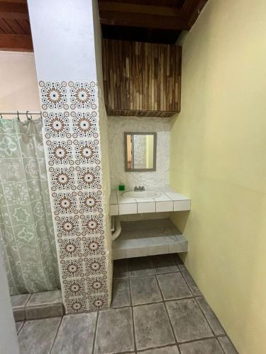 a bathroom with a sink and a mirror at Casa Susen in Montezuma