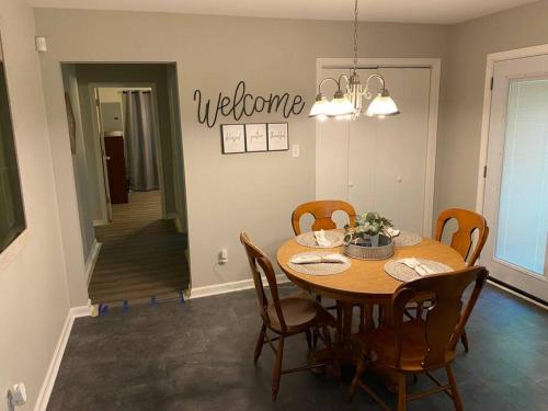 a dining room with a wooden table and chairs at 2-Bedroom Near Hospital and Casino in Pine Bluff