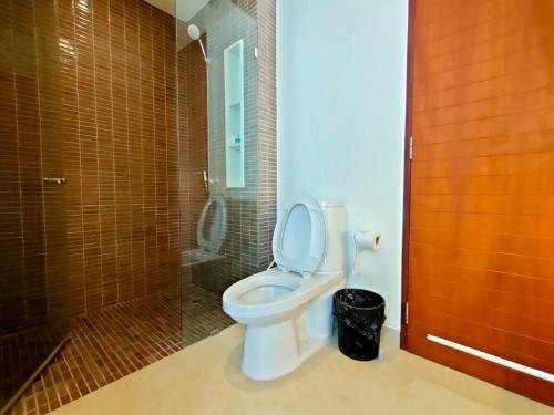a bathroom with a toilet and a glass shower at Pranaluxe 4 Bedroom Pool Villa C8 in Pran Buri