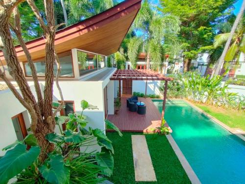 an image of a house with a swimming pool at Pranaluxe 4 Bedroom Pool Villa C8 in Pran Buri