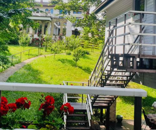 a view from the balcony of a house with red flowers at Rapsodia Pension in Suceava