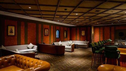 a waiting room with couches and chairs and a bar at Grand La Vogue Hotel and Casino in Sihanoukville