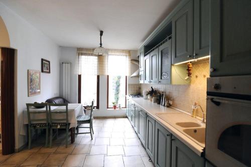 a kitchen with a table and a dining room at Rapsodia Pension in Suceava
