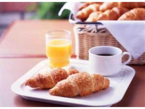 a plate of pastries and a cup of orange juice at R&B Hotel Shin Yokohama Ekimae - Vacation STAY 14692v in Yokohama