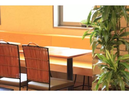 a table and chairs in a room with a window at R&B Hotel Shin Yokohama Ekimae - Vacation STAY 14692v in Yokohama
