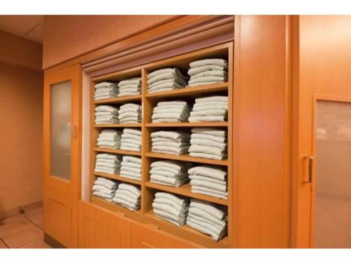 a cabinet filled with lots of white towels at R&B Hotel Shin Yokohama Ekimae - Vacation STAY 14692v in Yokohama