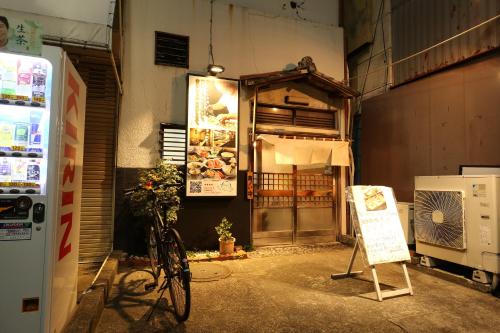 a bike is parked in front of a store at 東京スカイツリー眺望 一棟貸切 駅徒歩50秒 浅草8分 スカイツリー4分 銀座20分 in Tokyo