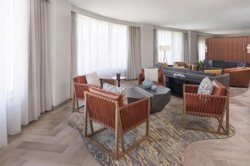 a living room with a couch and a table and chairs at The Westin Indianapolis in Indianapolis