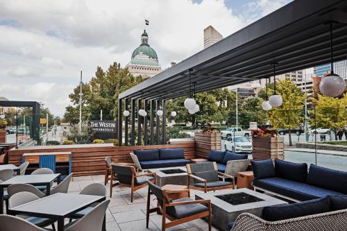 a patio with couches and tables and chairs at The Westin Indianapolis in Indianapolis