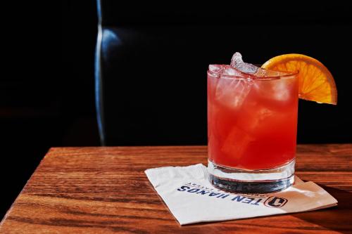 a drink sitting on a table with an orange slice at The Westin Indianapolis in Indianapolis