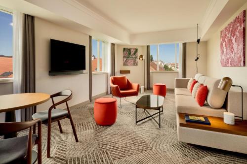 a living room with a couch and chairs and a table at Sheraton Zagreb Hotel in Zagreb