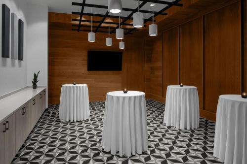 a conference room with four white tables in a room at Renaissance Columbus Westerville-Polaris Hotel in Westerville
