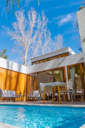 a house with a swimming pool next to a house at Aldea del Valle - Elqui Villas, Pisco Elqui in Pisco Elqui
