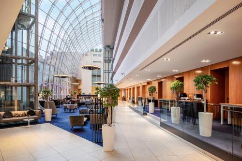 a lobby of a building with a glass ceiling at Ghent Marriott Hotel in Ghent