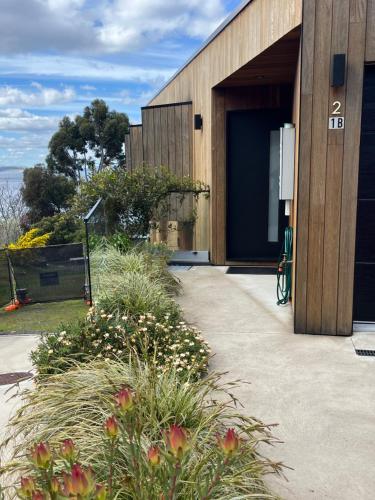 a building with a blue door and some plants at Fabulous, New, Well Appointed Beach House in Kingston Beach