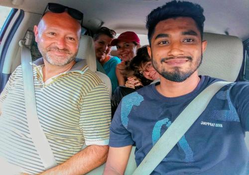 two men sitting in the back of a bus at Jm Resort in Dambulla