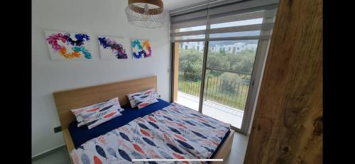 a bedroom with a bed and a large window at the best place in Karavas