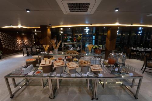 a buffet of food on a table in a restaurant at Paragon Hotel & Resort in Sreemangal