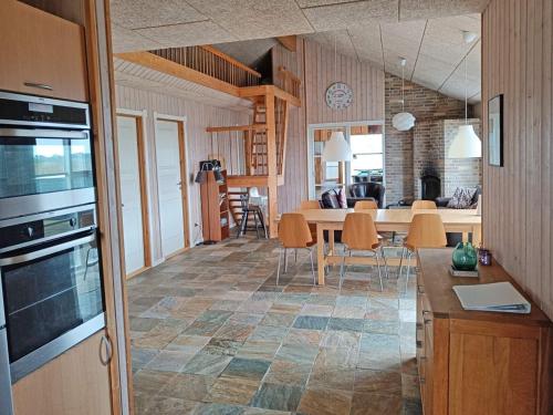 a kitchen and living room with a table and chairs at Luxury Retreat by Fjord - By Traum Ferienwohnungen in Tarm