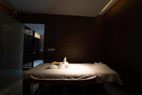 a bedroom with a bed with two cats on it at Paragon Hotel & Resort in Sreemangal