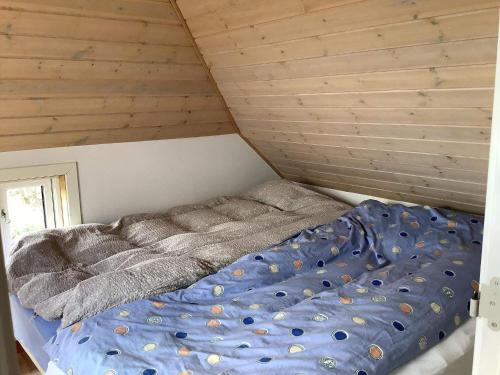 a bed in a room with a wooden ceiling at Panoramic View Fisherman's House - By Traum Ferienwohnungen in Vesløs