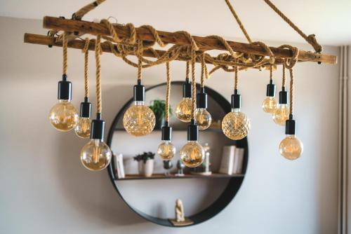 a bunch of light bulbs hanging from a chandelier at La Maison du Douanier Apach in Apach