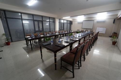 a large room with a long table and chairs at Paragon Hotel & Resort in Sreemangal