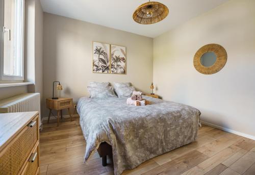 a bedroom with a bed with a teddy bear on it at La Maison du Douanier Apach in Apach