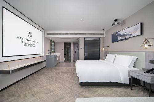 Ein Bett oder Betten in einem Zimmer der Unterkunft Meihao Lizi Hotel Taizhou Pozi Street Old Street Store