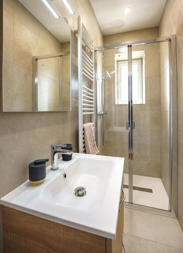 a bathroom with a sink and a shower at La Maison du Douanier Apach in Apach